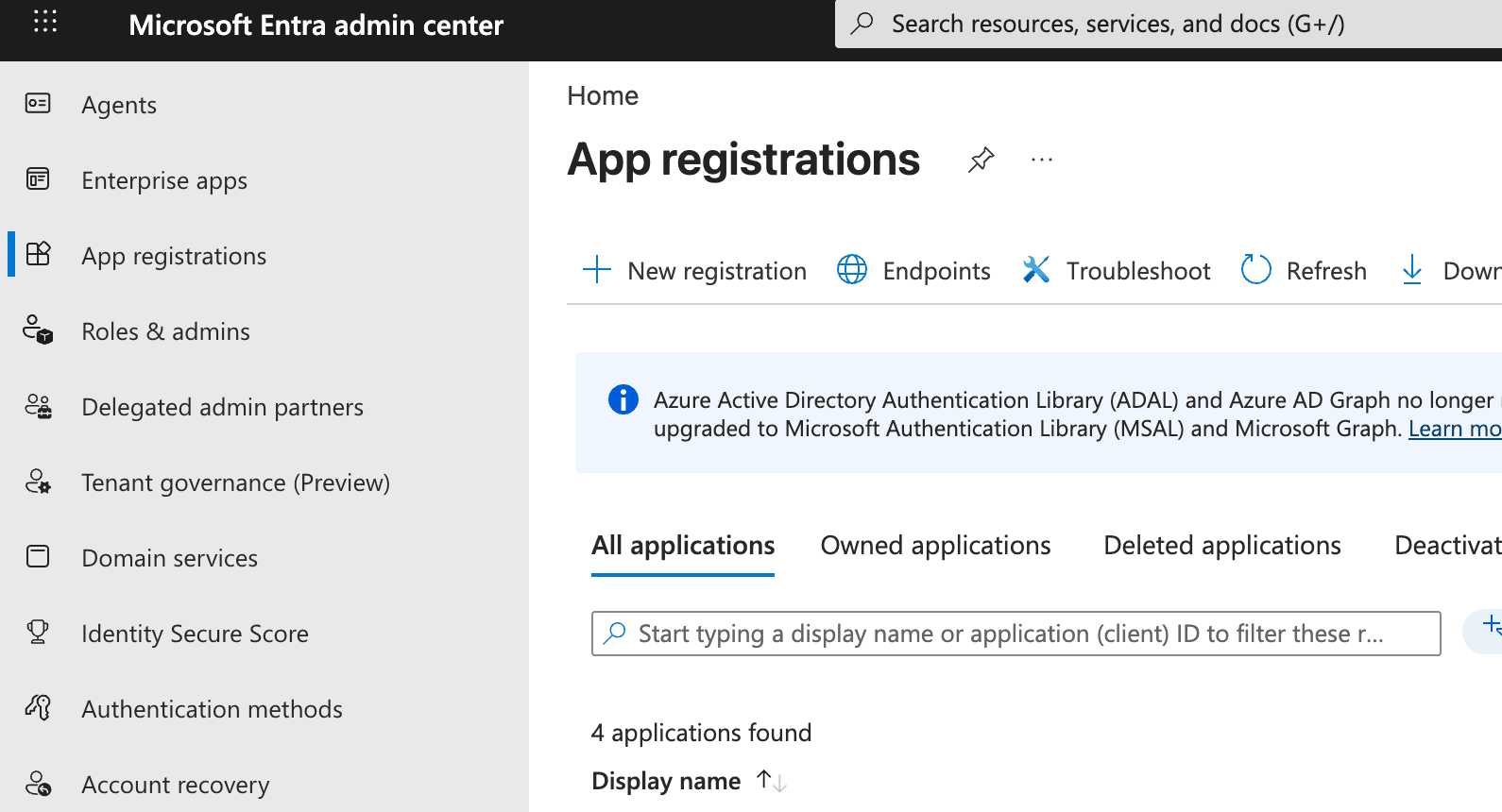 Entra admin center with "App registrations" selected in the sidebar and the "New registration" button